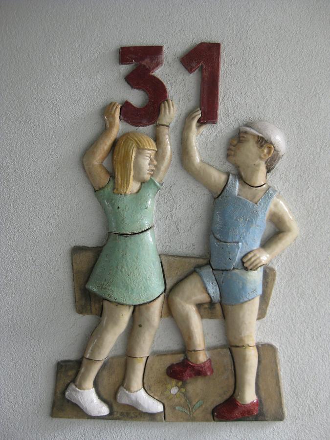 Keramikrelief-Hauszeichen 'Knabe und Mädchen mit Ziffer 31' von Hans Rauser 1952