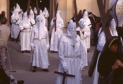 The Good Friday procession is also a procession of repenting sinners. Hooded repenters pull or carry crosses.