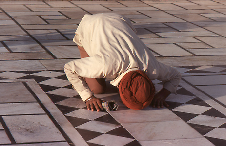 A prayer lying on the ground face down as sign of worship