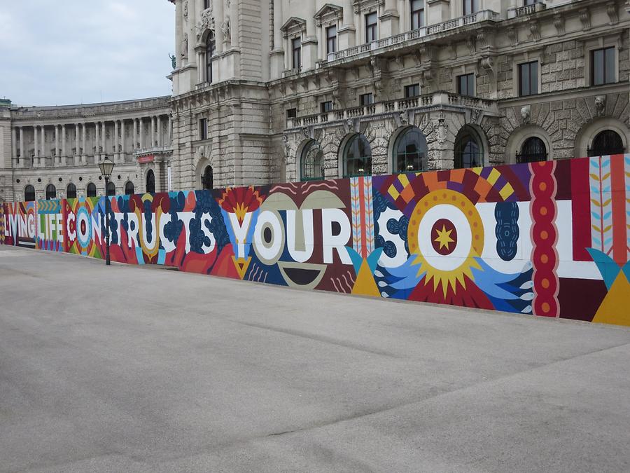 Weltmuseum-Bauzaun Street Art Graffito 'Living Life Constructs Your Soul' von Boa Mistura 2017