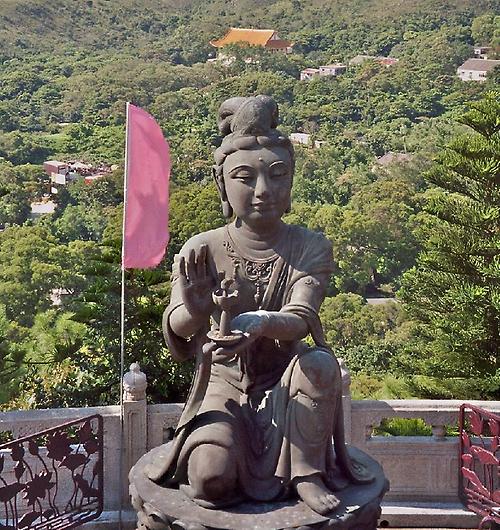 statue with monastery complex in the background