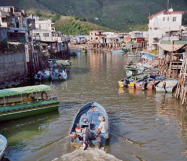 shabby houses on stilts and boats