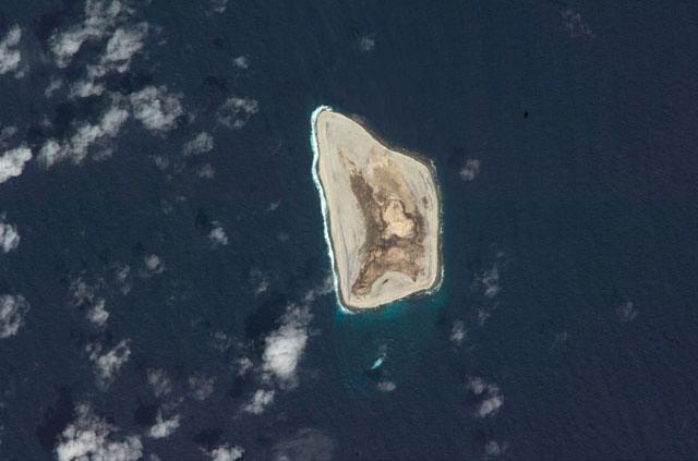 Satellite photo of Johnston Atoll, about 1,390 km (860 mi) west of Hawaii. Four islands compose the total land mass of 2.6 sq km. Johnston and Sand islands are both enlarged natural features, while Akau and Hikina are two artificial islands formed by coral dredging. Johnston Island, by far the largest, somewhat resembles the flattop of an aircraft carrier and contains an airstrip. Photo courtesy of NASA.