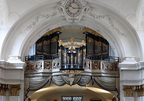 Orgel der ehemaligen Stiftkirche (Pfarrkirche) Dürnstein -Foto: © C.Stadler/Bwag; CC-BY-SA-4.0, Wikimedia Commons – Gemeinfrei. Die Dürnsteiner Stiftskirchenorgel ist ein barockes Juwel, das seit seiner Entstehungszeit nie verändert oder „verbessert“ wurde. Sie ist der süddeutsche Typ einer Barockorgel. Ursprünglich wurde sie 1719 gebaut und in der Vorsakristei aufgestellt. Vier Jahre später wurde sie auf den neuen Musikchor übertragen und vom Wiener Orgelbaumeister Johann Christoph Pan(t)zner um- und ausgebaut. Sie gilt als das einzige von ihm in Originalzustand erhalten gebliebene Werk. Zwei Manuale und Pedal mit 16 klingende Register, etwa 800 Pfeifen.