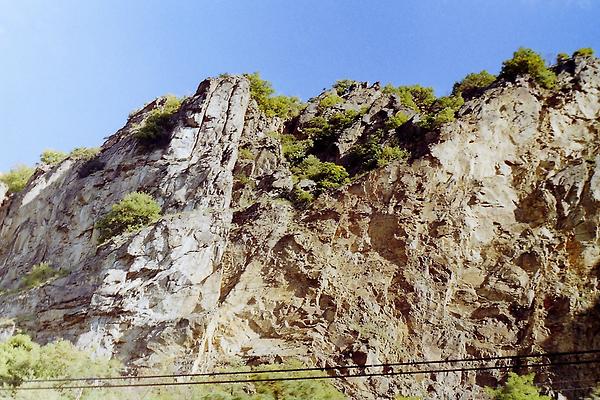 Wachau Donautal Gneisfelsen nahe Dürnstein, darunter die Strecke der Wachaubahn. In die schönsten 35 Kilometer Österreichs reicht nach Ansicht der Geologen die sogenannte Böhmische Masse. Manchmal fallen harte Gesteinsbrocken herunter. In der Domäne Wachau als Weinbaugebiet gibt es Gföhler Gneis, wenige Amphibolitgesteine und Paragneis sowie tertiäre Sedimente (sandig-kiesige Flussablagerungen und teilweise verlehmte Staubanwehungen der letzten Eiszeit) - Während Pkw-Fahrt als Beifahrer fotografiert - Foto: Ernst Zentner (August 1988)