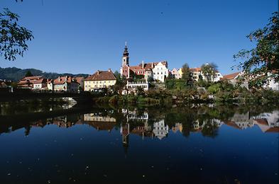 Ein Teil der Muransicht von Frohnleiten. Seit der Fertigstellung des Kraftwerks Rabenstein spiegeln sich die Häuser über der Geländekante im aufgestauten Wasser.