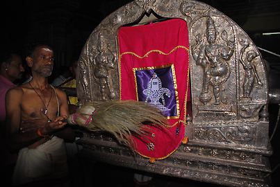 Priests with a frond (camara) are chasing away evil spirits