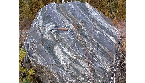 Typisches Erscheinungsbild der 2.7 Milliarden-Jahre alten gebänderten Eisenformation im Temagami Grünsteingürtel in Kanada. Die Mächtigkeit der charakteristischen Eisen- (dunkelgrau) und Quarzreichen (hellgrau) Lagen in dem Boulder dieser BIF variieren zwischen einigen Millimetern bis zu mehreren Zentimetern.