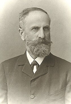 Karl Brunner mit langem Bart und in dunklem Anzug