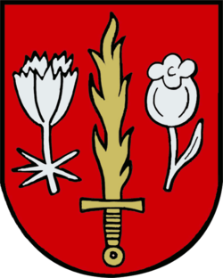 GemeindeTarsdorfIn Rot ein goldenes Flammenschwert, begleitet rechts von einer silbernen Waldmeisterblüte mit silbernem Stiel und silbernen Blättern, links von einer silbernen Rosmarinheideblüte mit silbernem Stiel und einem silbernen Blatt.